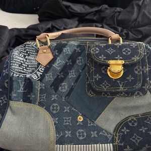 Blue Shoulder Bag with Gold Accents and Monogram Design